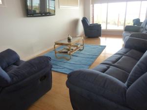 a living room with two couches and a coffee table at Lincoln View Holiday House in North Shields