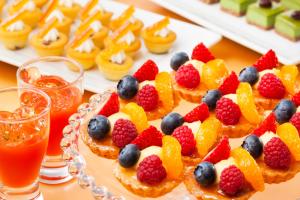 a plate of fruit tarts with fruit on top of it at Century Royal Hotel Sapporo in Sapporo