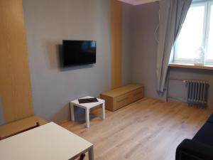 a living room with a flat screen tv on the wall at Nordic Apartamenty Malmeda in Białystok