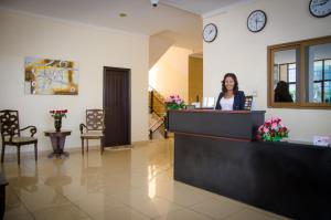 a woman standing at a cash register in a lobby at Union Hotel Apartments in Addis Ababa