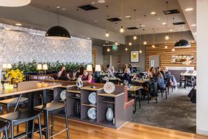 a restaurant with people sitting at tables at Abode Woden in Canberra