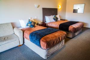 מיטה או מיטות בחדר ב-City Central Motel Apartments