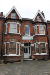 an old red brick building with a white door at The Wimbledon Hotel in London