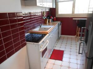 a kitchen with a sink and a stove top oven at Gite Clemenceau in Rouen