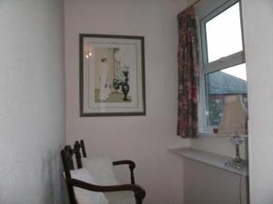 a living room with a chair and a window at Glenleigh Bed and Breakfast in Marazion +89 photos