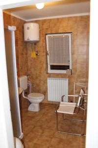 a bathroom with a toilet and a window at Apartments Vila Marica in Rabac +73 photos
