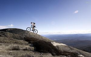 a person riding a bike on top of a mountain at TANIT Hotel Ristorante Storia del SulcisIglesiente in Carbonia