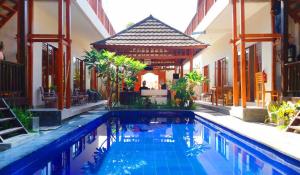 a swimming pool in the middle of a house at Gili Desa in Gili Trawangan