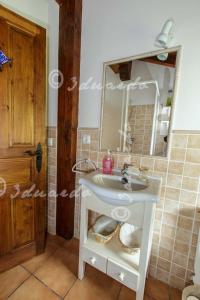a bathroom with a white sink and a mirror at Apartamentos Casa Placida 1 in Frama +11 photos