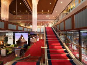 a red carpeted staircase in a shopping mall at Garden hotel Shiunkaku Higashimatsuyama in Matsuyama