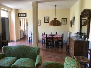 a living room and dining room with a table and chairs at Country House La Viscarda in Tortona