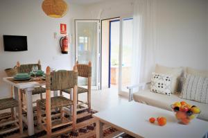 a living room with a table and a dining room at Siamoformentera Valentina in Sant Francesc Xavier