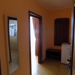 a bathroom with a mirror and a door to a room at Casa Rad in Sînmartin