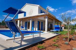 a villa with a pool and a swing at Villa Milohnici Florian in Milohnići