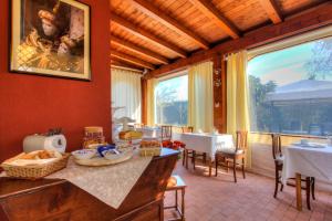 una sala da pranzo con tavolo, sedie e una grande finestra di B&B A Casa di Marta a Cavallino-Treporti