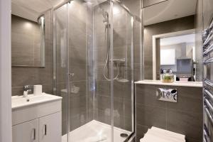 a bathroom with a shower and a sink at Nelson Mandela Place Apartments in Glasgow