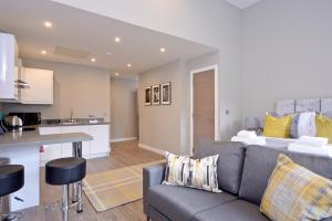 a living room filled with furniture and a kitchen at Destiny Scotland Apartments at Nelson Mandela Place in Glasgow