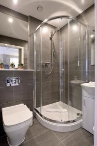 a bathroom with a shower, toilet and sink at Destiny Scotland Apartments at Nelson Mandela Place in Glasgow