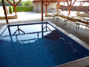 a swimming pool with tables and chairs around it at Restaurace Vráž in Trhové Sviny