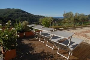 una fila de mesas de picnic en una terraza con vistas en Villa Paggi Country House en Carasco
