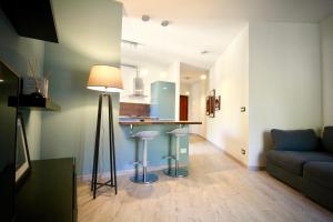 a living room with a couch and a kitchen at Pepe Nero in Bordighera