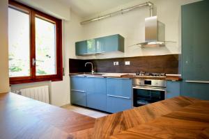 a kitchen with blue cabinets and a sink at Pepe Nero in Bordighera
