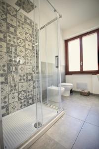a bathroom with a glass shower and a toilet at Pepe Nero in Bordighera
