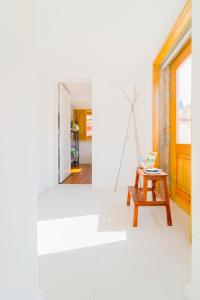 a living room with a table and a window at Aguda Beach Charming House by MP in Vila Nova de Gaia