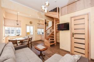 a living room with a couch and a table at Manto Apartamentai in Druskininkai