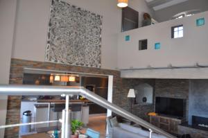 a living room with a stone wall and a staircase at Belle maison avec piscine dans les hauteurs à Saint Raphael in Saint-Raphaël