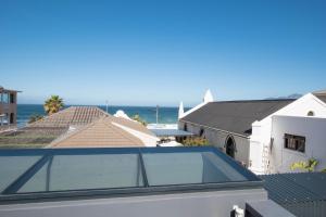 a view of the ocean from the roof of a house at Rosmead Apartment in Kalk Bay