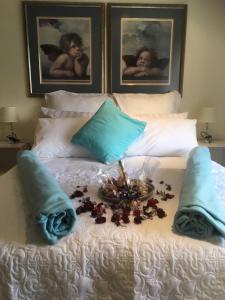 a white bed with a tray of flowers on it at Sunninghill Sojourn in Kyalami