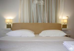 A bed or beds in a room at Chania Lissosaparments