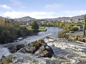 a river with rapids and rocks in a town at River House in Hollywood