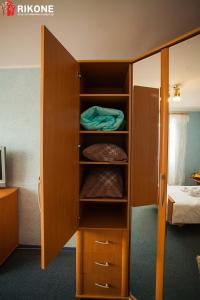チュメニにある1к УЮТНАЯ Выстовочный Энергетиков 62аのベッドルームに木製キャビネット付きのクローゼットが備わります。