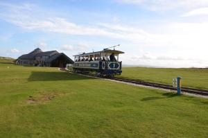 a small train with people riding on the tracks at Audley Guest House in Llandudno
