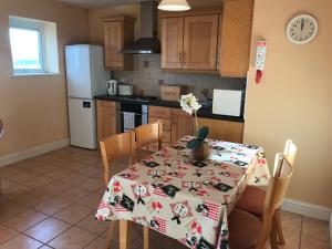a kitchen with a table with a table cloth on it at Kings Court Holiday Apartments in Tralee