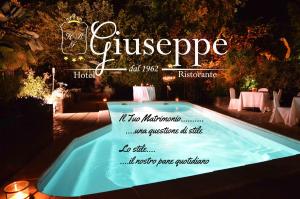 a sign for a swimming pool at night at Albergo Ristorante Da Giuseppe in Copparo
