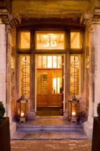 a front door of a building with two lights at Grand Hotel Alkmaar in Alkmaar