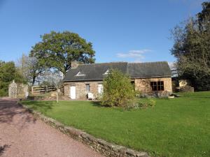 an old stone house with a grass yard at Le presbytère de Brectouville in Brectouville