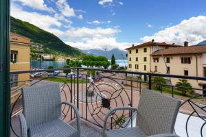 a balcony with two chairs and a table at Residence Riva del Lario in Gravedona