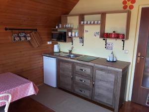 a kitchen with a sink and a counter top at Apartma pod Rožco in Jesenice