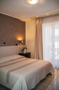 Łóżko lub łóżka w pokoju w obiekcie Hotel Regina