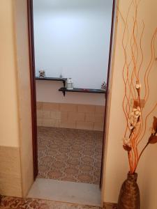 a bathroom with a glass door leading into a shower at Bilocale Mini Very in San Vito lo Capo