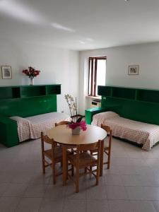 a room with two beds and a table and chairs at Casa Bagatta in Desenzano del Garda