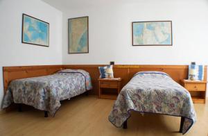 a bedroom with two beds and two night stands at Country House Ramandolo Club in Nimis