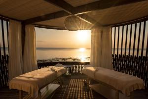 a room with two beds and a view of the ocean at Essque Zalu Zanzibar in Nungwi