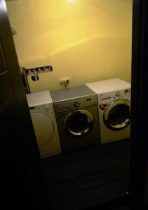 a laundry room with two washing machines in it at Daeli Hotel in Mestia