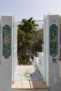 a white gate with a mosaic on the floor at Positano Suite in Positano