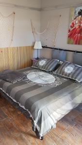 an unmade bed with a white comforter and pillows at La Papaya in Marina di Pisa